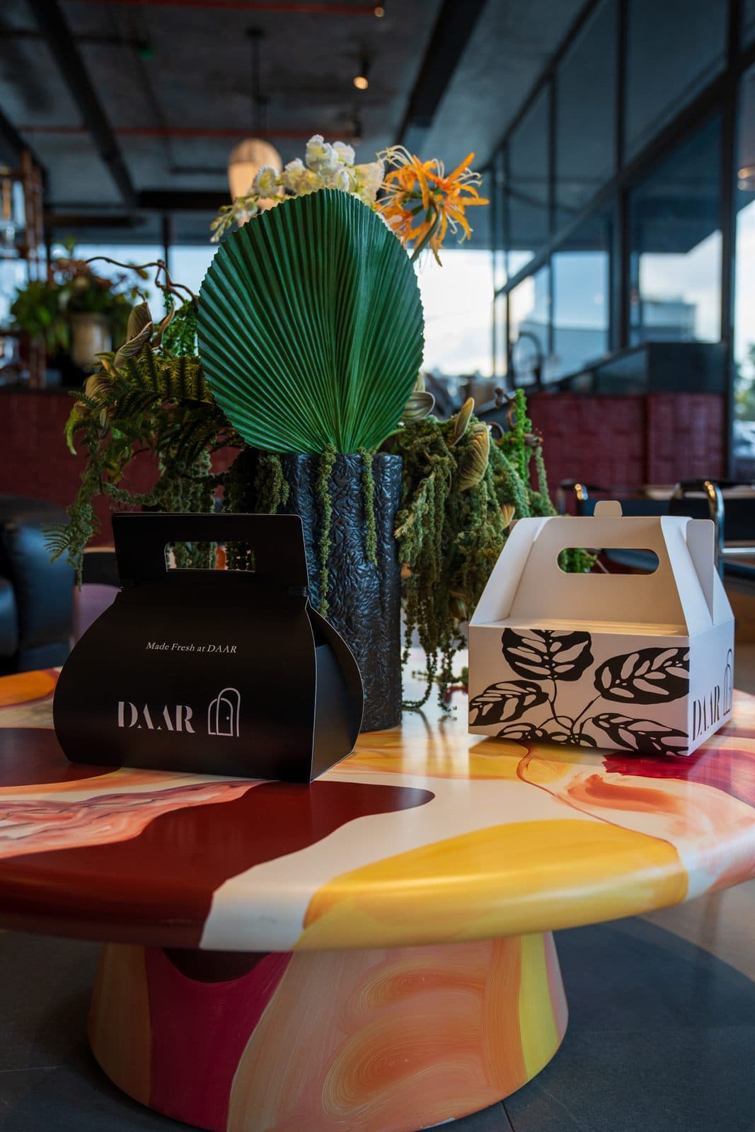 Inside Daar — takeaway boxes on a paint-marbled table