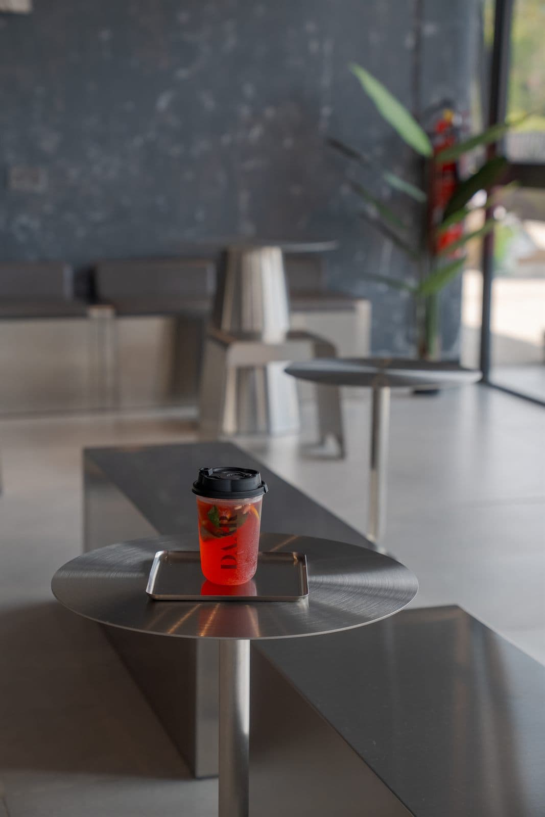 Inside Daar — brushed steel against the plaster wall